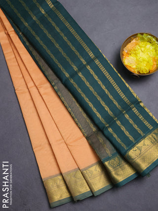 Silk cotton saree pale orange and bottle green with plain body and zari woven border