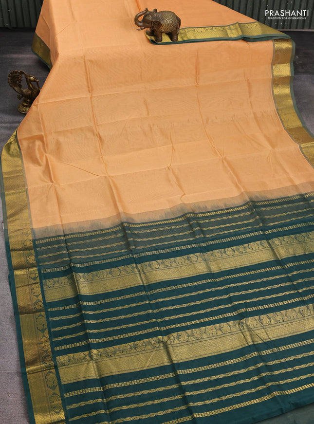 Silk cotton saree pale orange and bottle green with plain body and zari woven border