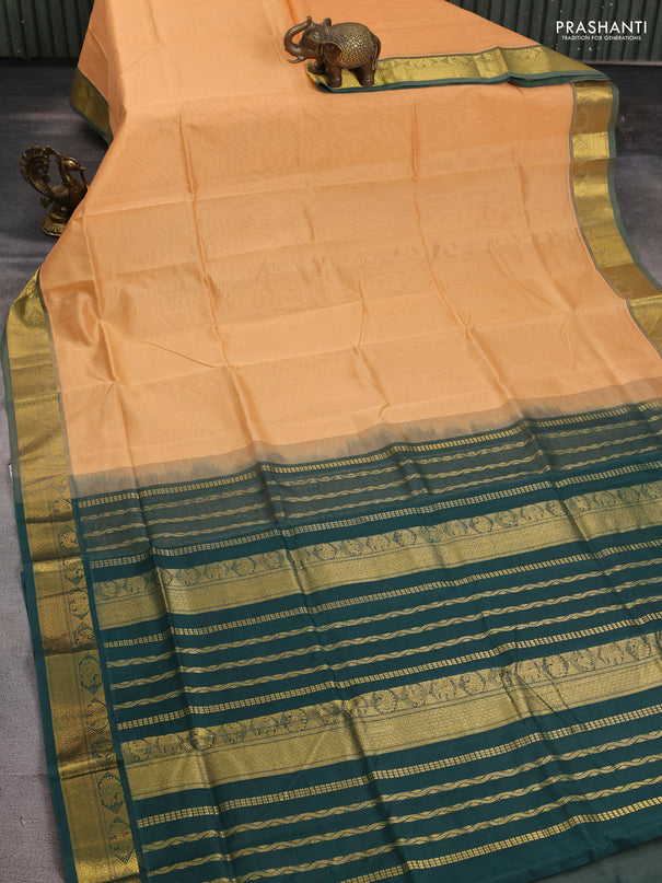 Silk cotton saree pale orange and bottle green with plain body and zari woven border