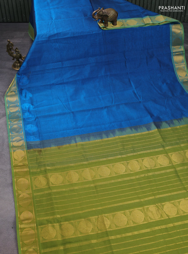 Silk cotton saree peacock blue and mehendi green with plain body and rudhraksha zari woven border