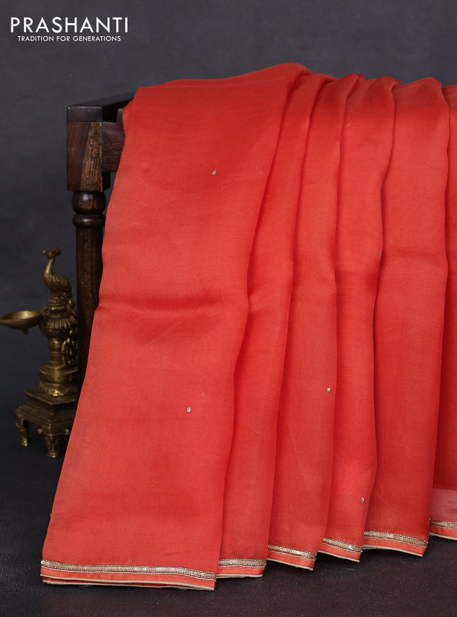Pure organza silk saree orange with embroidery zari buttas and sequin embroidered border
