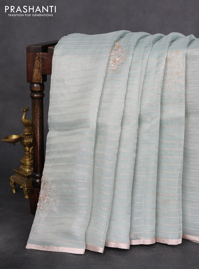 Pure organza silk saree pastel blue shade with allover zari stripe pattern & zardosi work and zari woven piping border