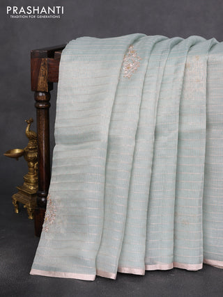 Pure organza silk saree pastel blue shade with allover zari stripe pattern & zardosi work and zari woven piping border