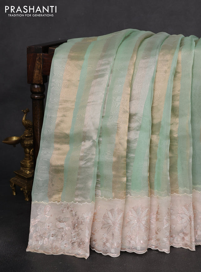 Pure organza silk saree pastel green and cream with allover silver & gold stripes pattern and embroidery border