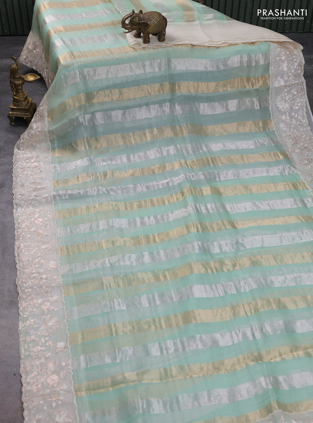 Pure organza silk saree pastel green and cream with allover silver & gold stripes pattern and embroidery border