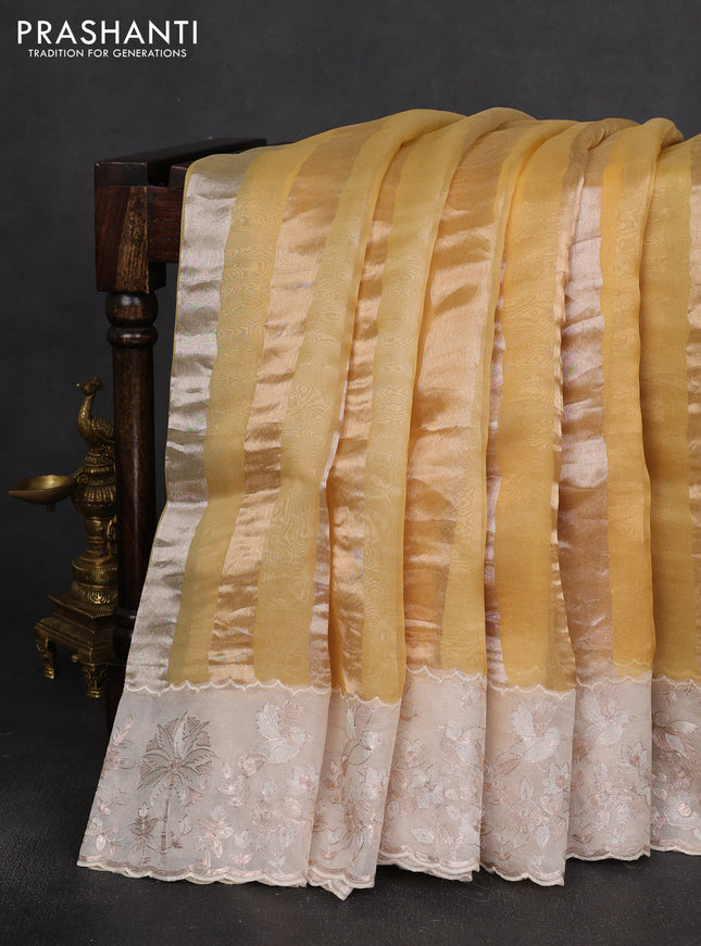 Pure organza silk saree yellow and cream with allover silver & gold stripes pattern and embroidery border
