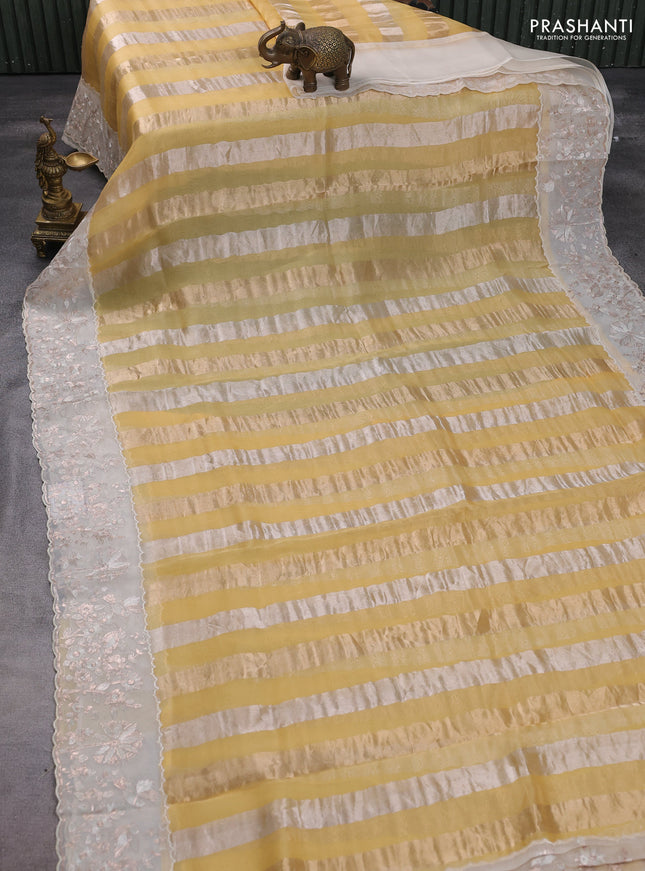 Pure organza silk saree yellow and cream with allover silver & gold stripes pattern and embroidery border