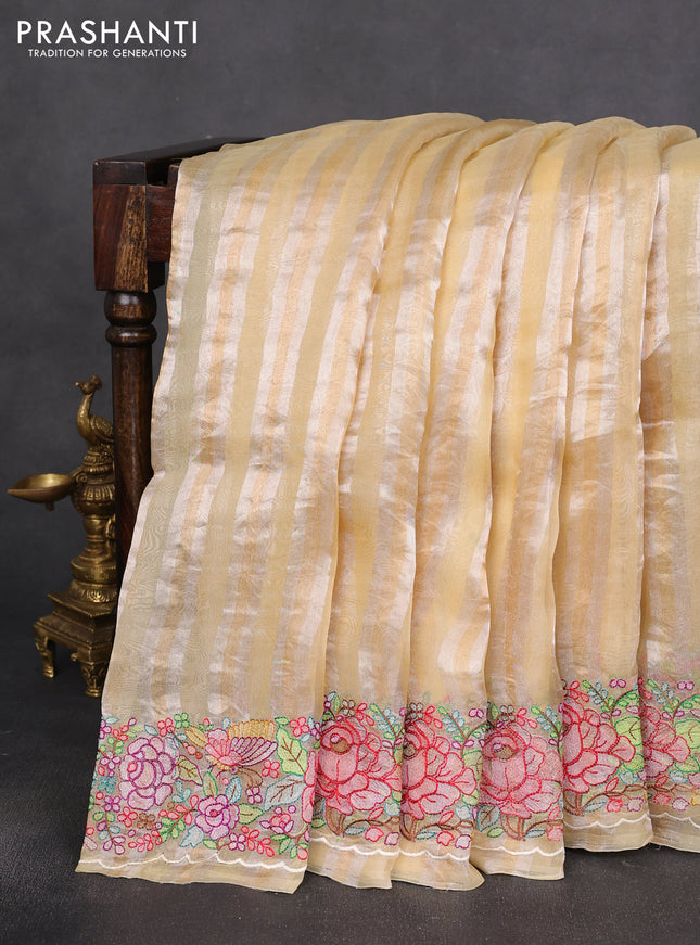 Pure organza silk saree pale yellow with allover silver & gold stripes pattern and embroidered border