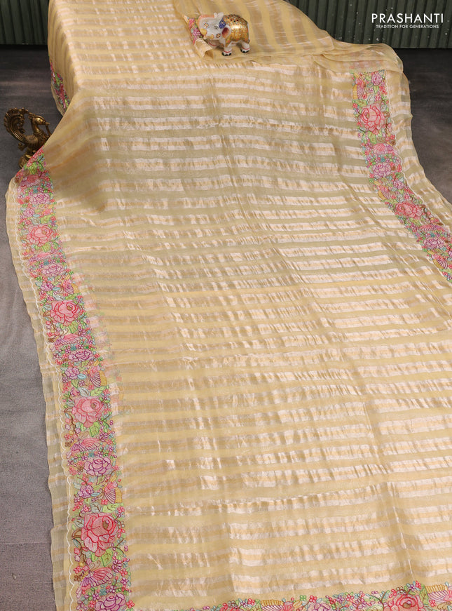 Pure organza silk saree pale yellow with allover silver & gold stripes pattern and embroidered border