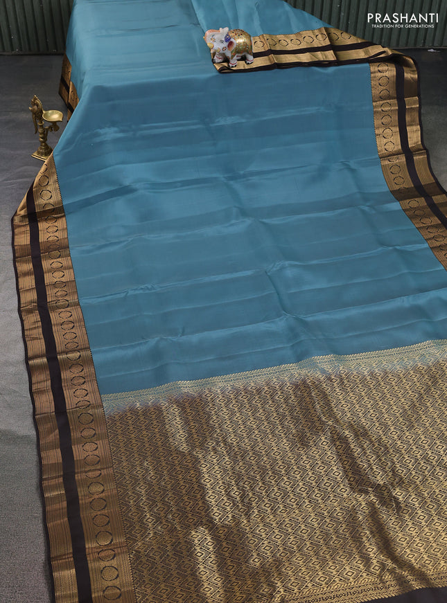 Kanchipuram silk saree pastel blue and coffee brown with plain body and rettapet zari woven border