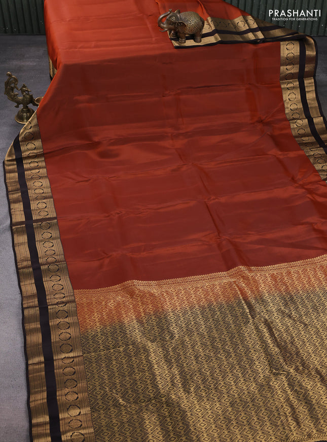 Kanchipuram silk saree rustic orange and coffee brown with plain body and rettapet zari woven border