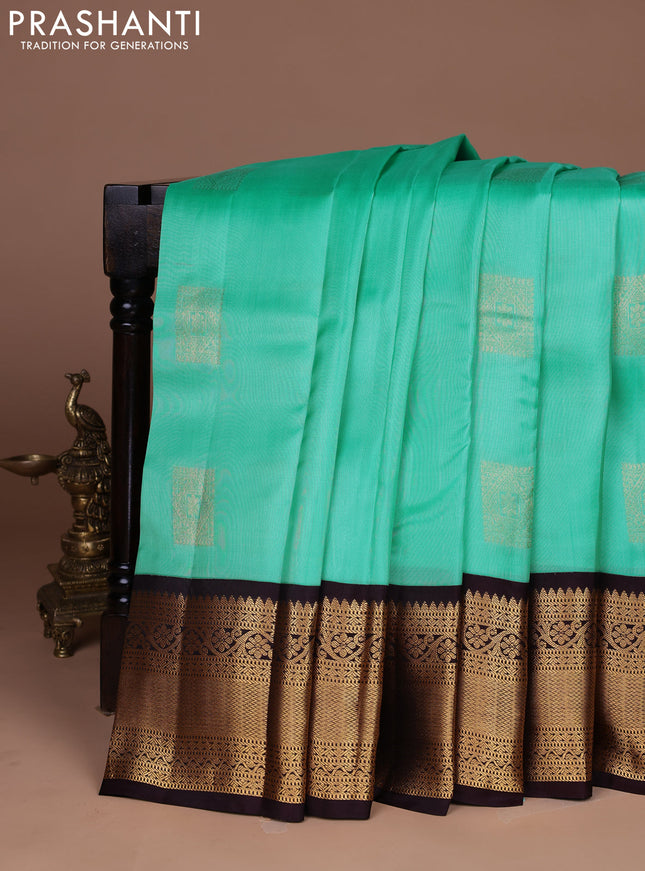 Kanchipuram silk saree teal green and coffee brown with allover zari woven buttas and long zari woven border