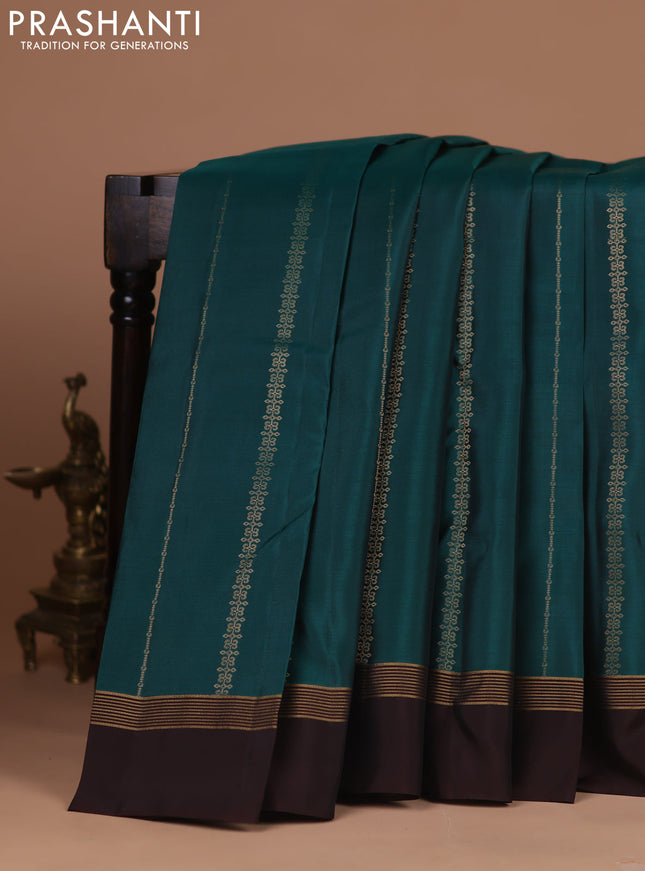 Kanchipuram silk saree green and coffee brown with allover zari weaves and zari woven simple border