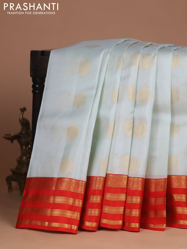 Kanchipuram silk saree pastel green shade and orange with zari woven buttas and zari woven korvai border