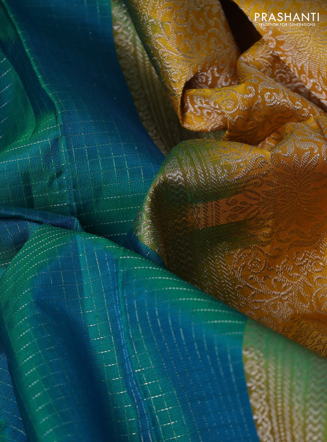 Pure soft silk saree dual shade of teal bluish green and yellow with allover silver zari checked pattern and paisley silver zari woven butta border