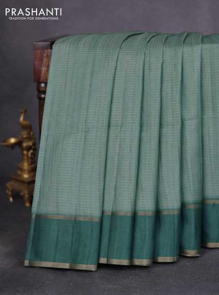 Semi matka saree teal green with allover zari weaves and rettapet zari woven border