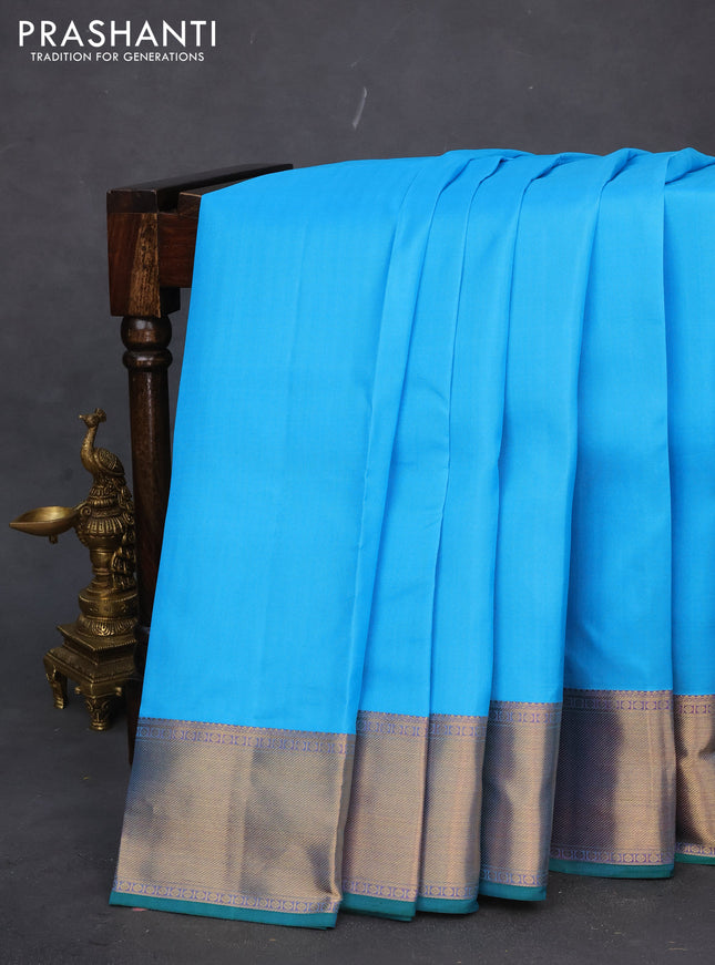 Pure kanchipuram silk saree light blue and dual shade of bluish pink with plain body and rich zari woven border