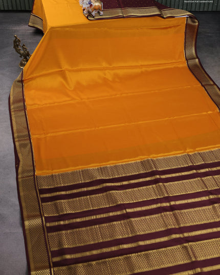 Pure mysore partly silk saree mustard yellow and brown with plain body and zari woven border