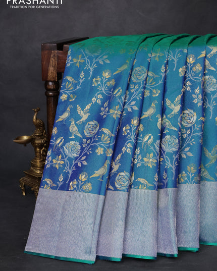 Pure kanchipuram silk saree dual shade of teal green with bird motif weaves and silver zari woven border
