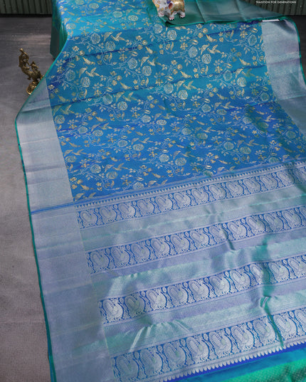 Pure kanchipuram silk saree dual shade of teal green with bird motif weaves and silver zari woven border