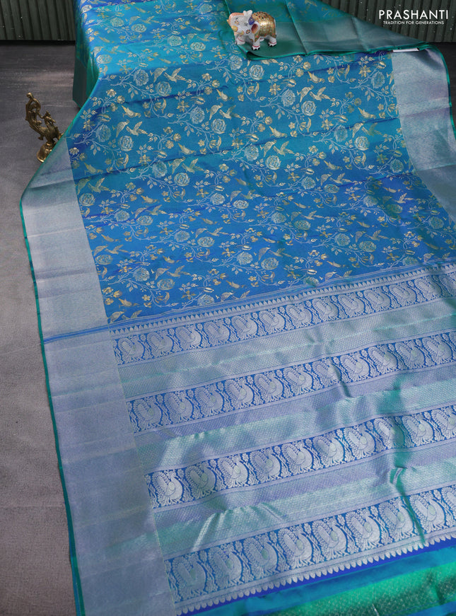 Pure kanchipuram silk saree dual shade of teal green with bird motif weaves and silver zari woven border
