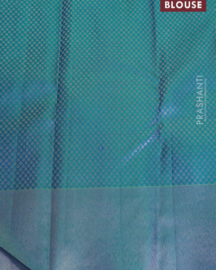 Pure kanchipuram silk saree dual shade of teal green with bird motif weaves and silver zari woven border