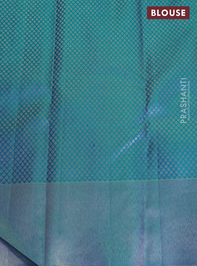 Pure kanchipuram silk saree dual shade of teal green with bird motif weaves and silver zari woven border