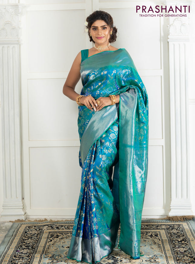 Pure kanchipuram silk saree dual shade of teal green with bird motif weaves and silver zari woven border