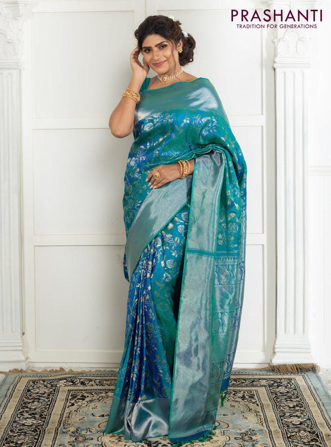 Pure kanchipuram silk saree dual shade of teal green with bird motif weaves and silver zari woven border