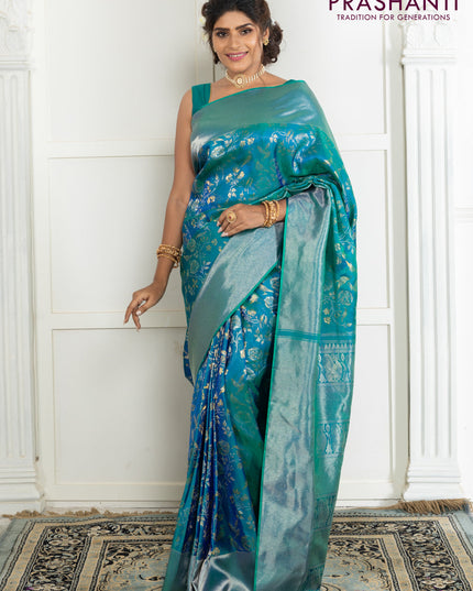Pure kanchipuram silk saree dual shade of teal green with bird motif weaves and silver zari woven border