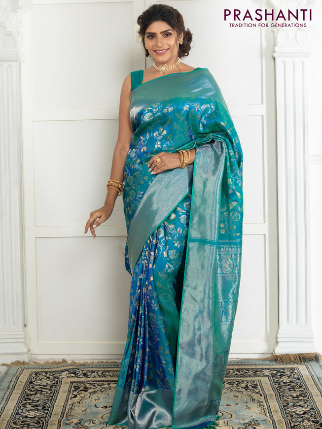Pure kanchipuram silk saree dual shade of teal green with bird motif weaves and silver zari woven border