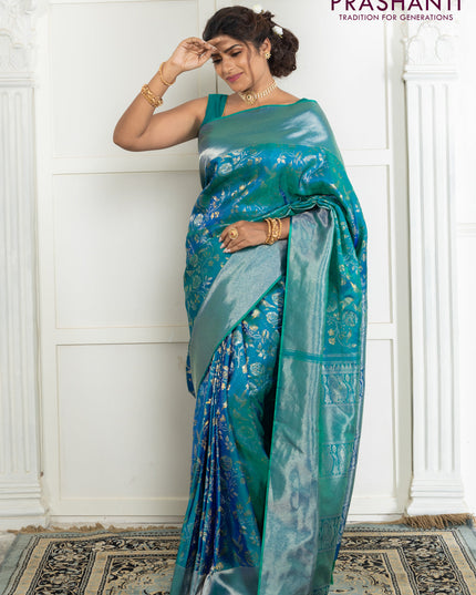 Pure kanchipuram silk saree dual shade of teal green with bird motif weaves and silver zari woven border
