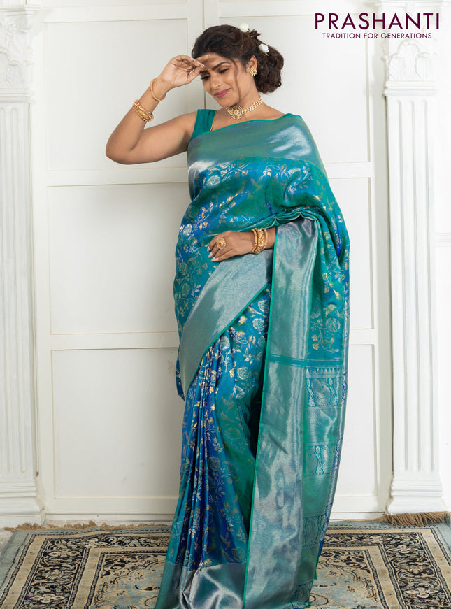 Pure kanchipuram silk saree dual shade of teal green with bird motif weaves and silver zari woven border