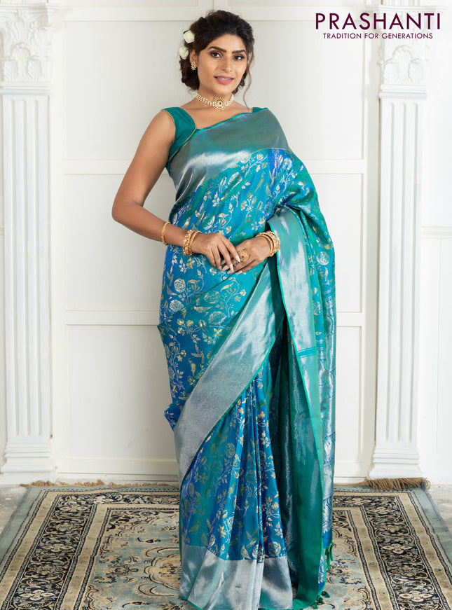 Pure kanchipuram silk saree dual shade of teal green with bird motif weaves and silver zari woven border