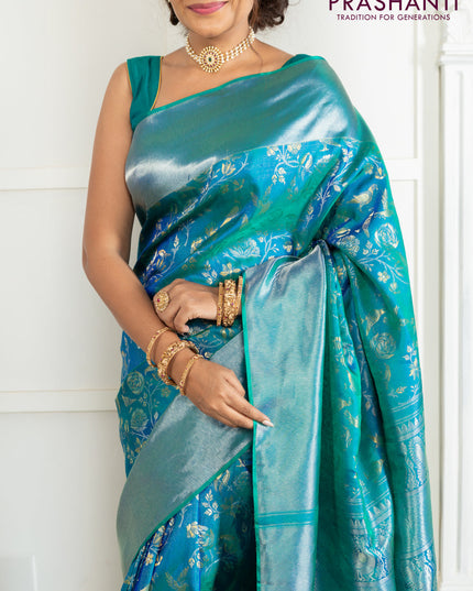 Pure kanchipuram silk saree dual shade of teal green with bird motif weaves and silver zari woven border
