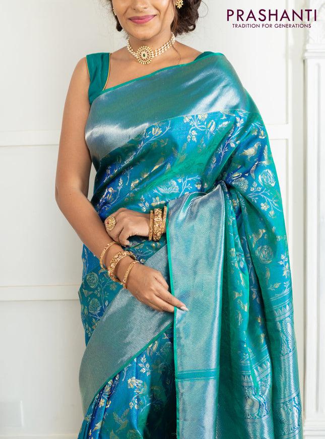 Pure kanchipuram silk saree dual shade of teal green with bird motif weaves and silver zari woven border
