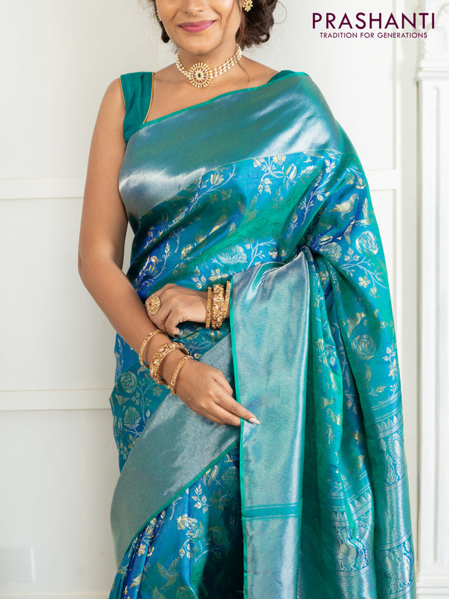 Pure kanchipuram silk saree dual shade of teal green with bird motif weaves and silver zari woven border