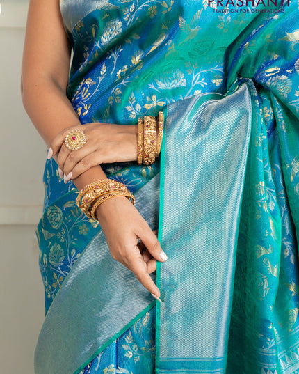 Pure kanchipuram silk saree dual shade of teal green with bird motif weaves and silver zari woven border