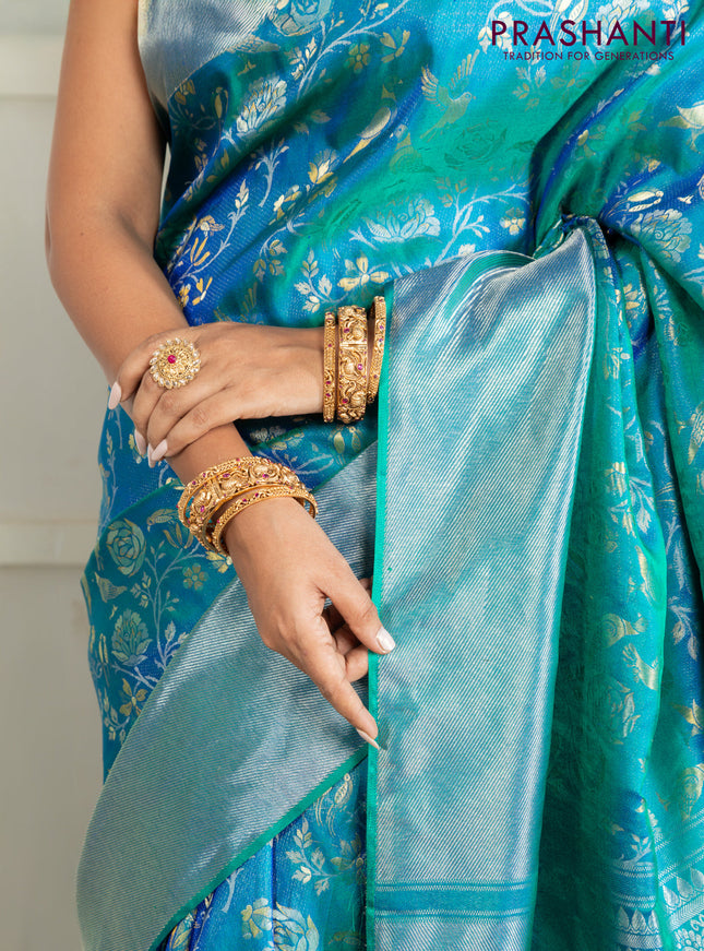 Pure kanchipuram silk saree dual shade of teal green with bird motif weaves and silver zari woven border