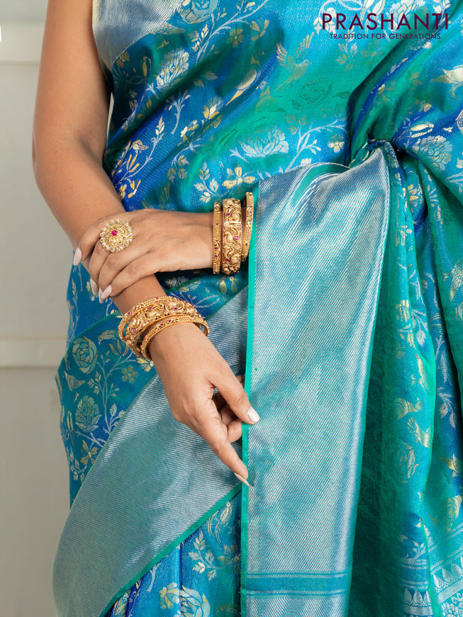 Pure kanchipuram silk saree dual shade of teal green with bird motif weaves and silver zari woven border