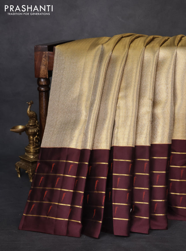 Pure kanchipuram tissue silk saree gold and deep maroon with allover zari woven brocade weaves and muniya butta zari woven border