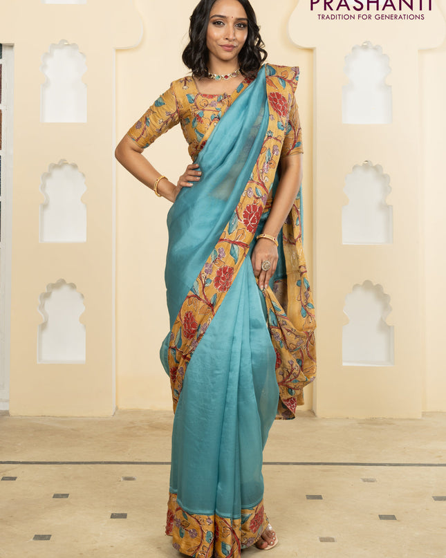 Pure organza silk saree pastel blue and sandal with plain body and kalamkari printed pita work border