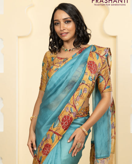 Pure organza silk saree pastel blue and sandal with plain body and kalamkari printed pita work border
