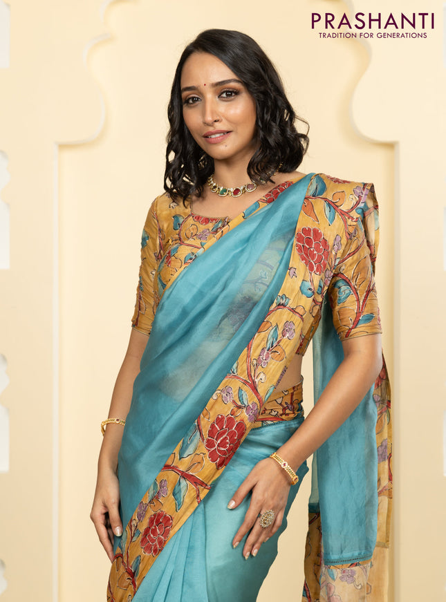 Pure organza silk saree pastel blue and sandal with plain body and kalamkari printed pita work border