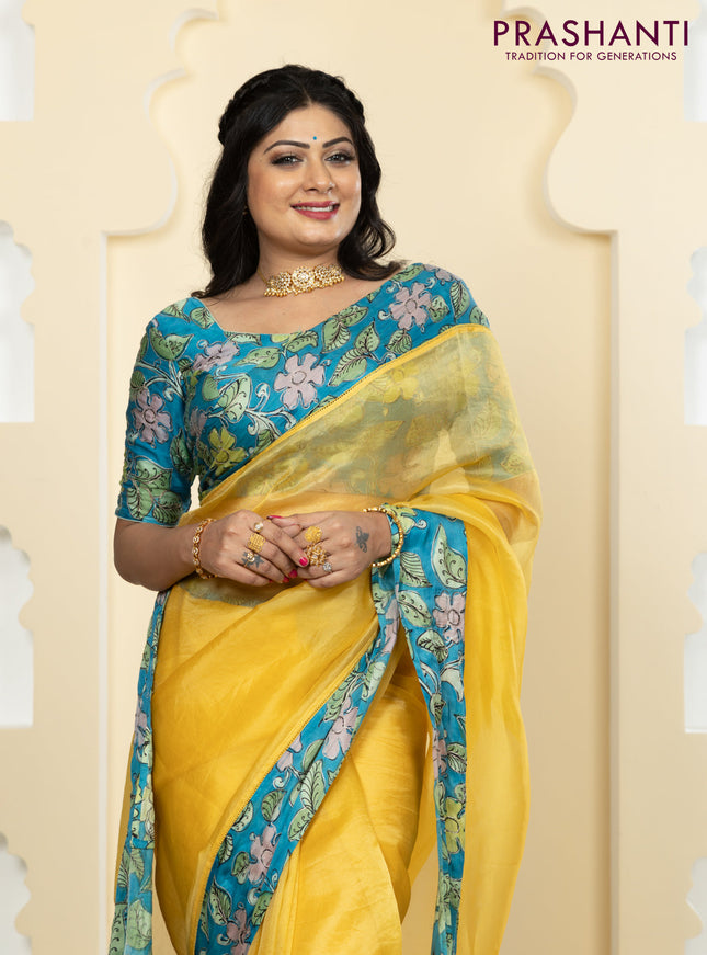 Pure organza silk saree yellow and cs blue with plain body and kalamkari printed pita work border