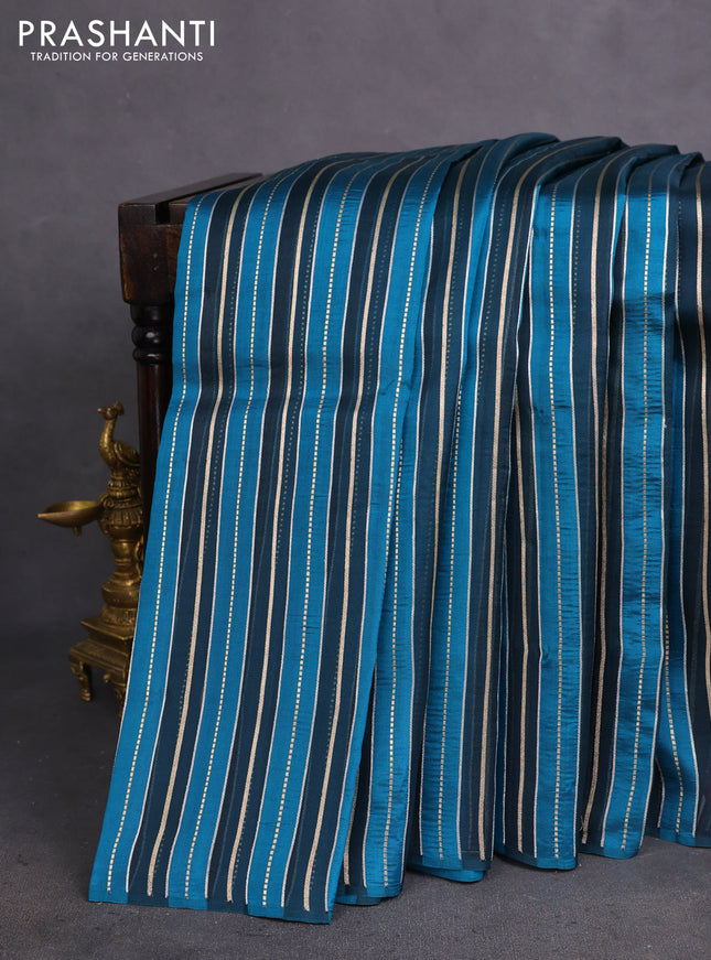 Pure organza silk saree dark peacock blue and peacock blue with allover silver & gold zari woven stripe pattern in borderless style