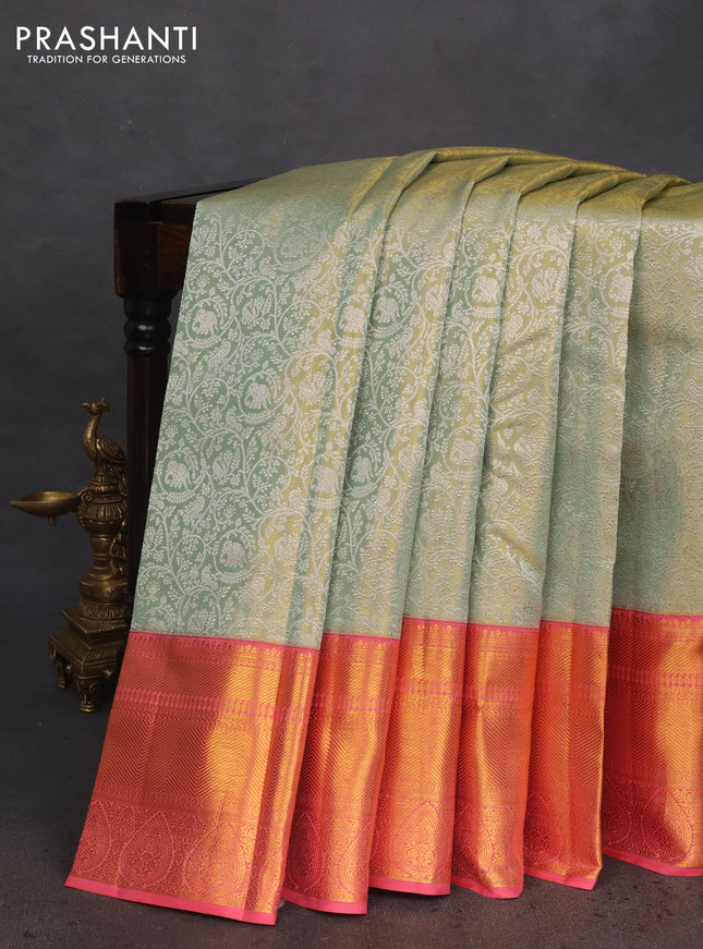 Pure kanchipuram tissue silk saree pastel green and peach pink with allover silver zari woven brocade weaves and long zari woven border