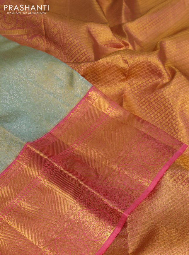 Pure kanchipuram tissue silk saree pastel green and peach pink with allover silver zari woven brocade weaves and long zari woven border