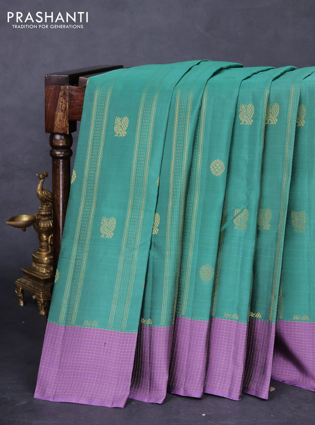 Kanchipuram silk saree teal green shade and pastel purple with allover zari weaves & buttas and zari woven checked border