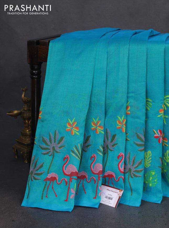 Silk cotton saree dual shade of teal blue with plain body and long kutchi embroidery border